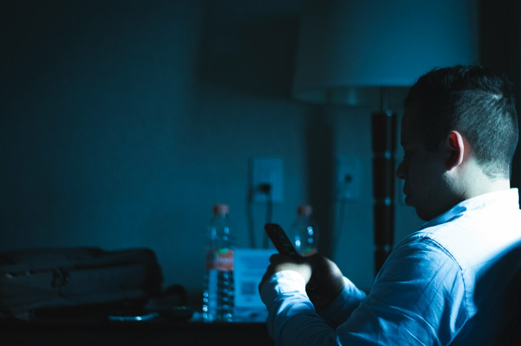 investigator using emf meter at night