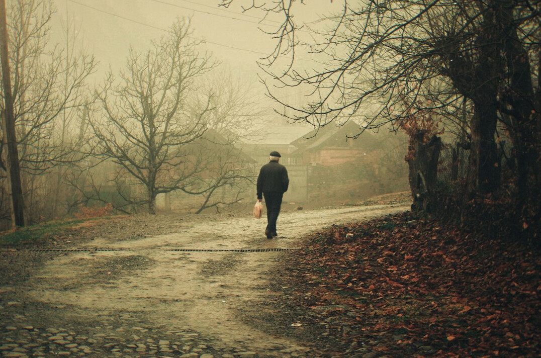 man walking alone on rural road
