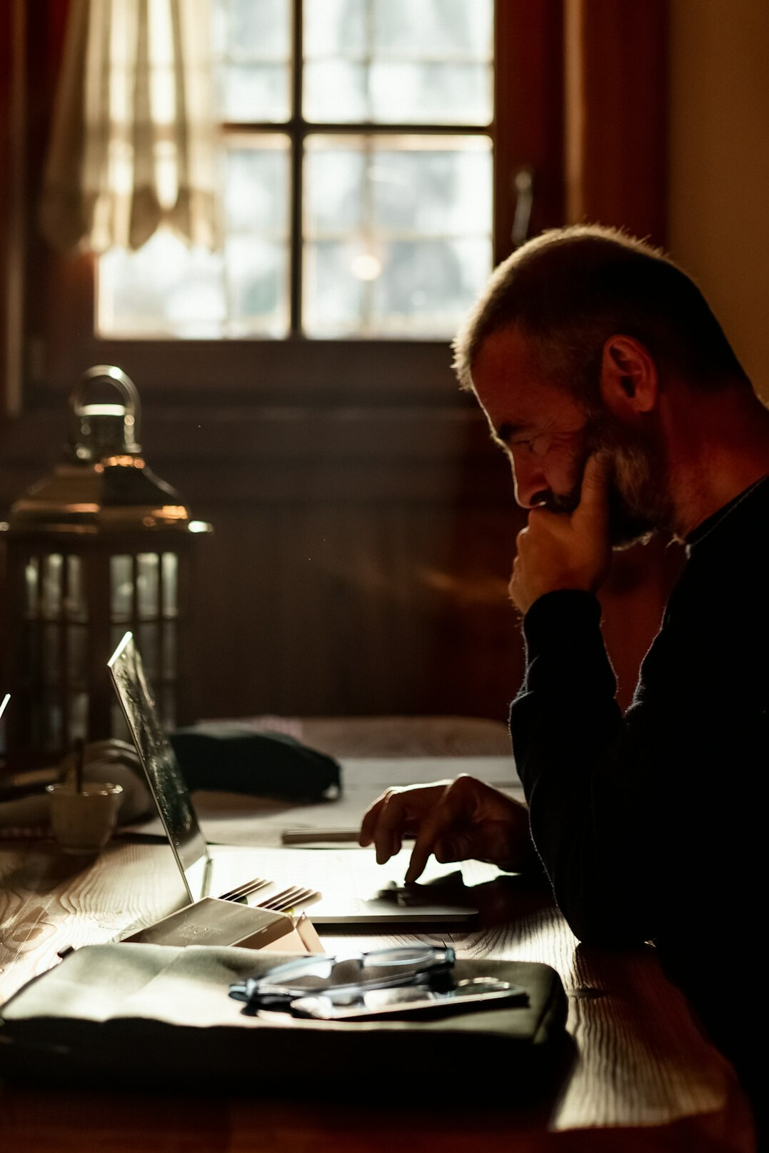 researcher writing notes by candlelight